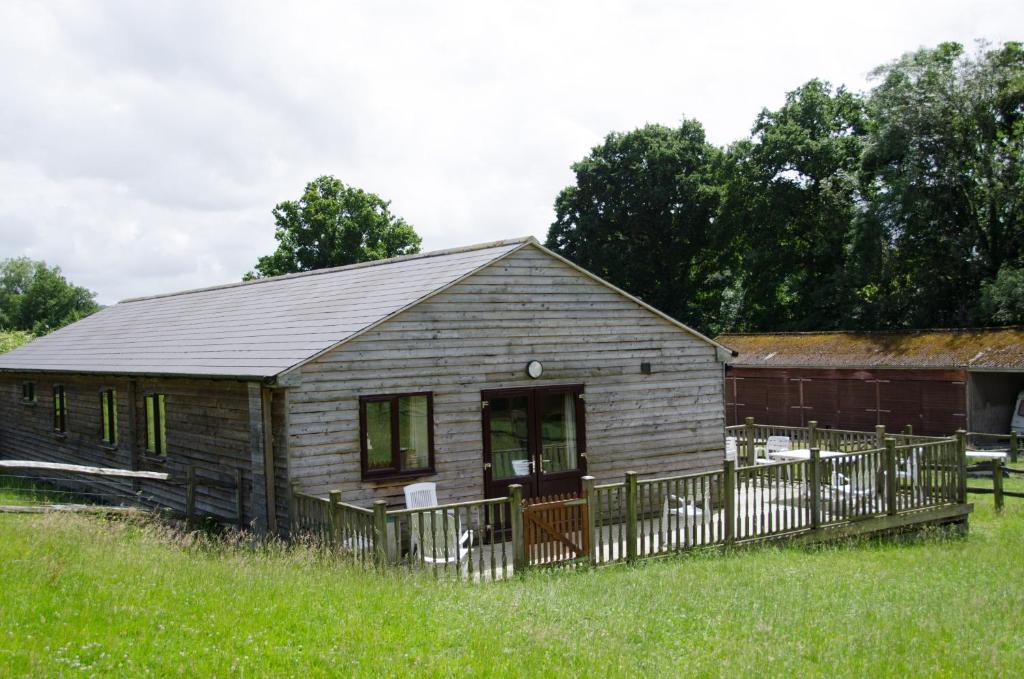 an old wooden house in a field of grass at Accessible Barn 4 Bedrooms Farm stay sleeps 8 in Mayfield