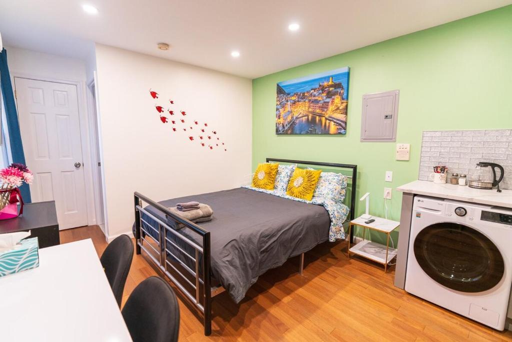 a bedroom with a bed and a washing machine at New! Suite near Rittenhouse Square in Philadelphia