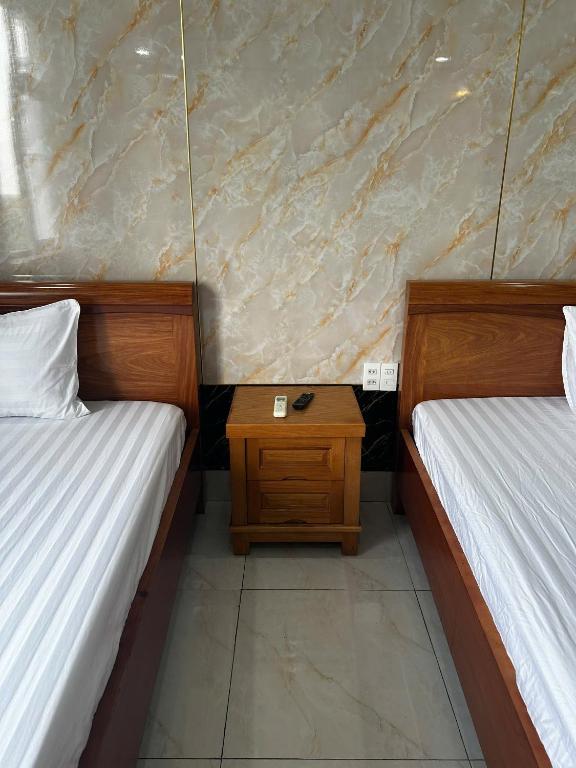 Postel nebo postele na pokoji v ubytování Thulee Luxury Hotel - Phu My