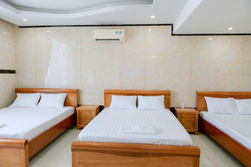 Postel nebo postele na pokoji v ubytování Thulee Luxury Hotel - Phu My
