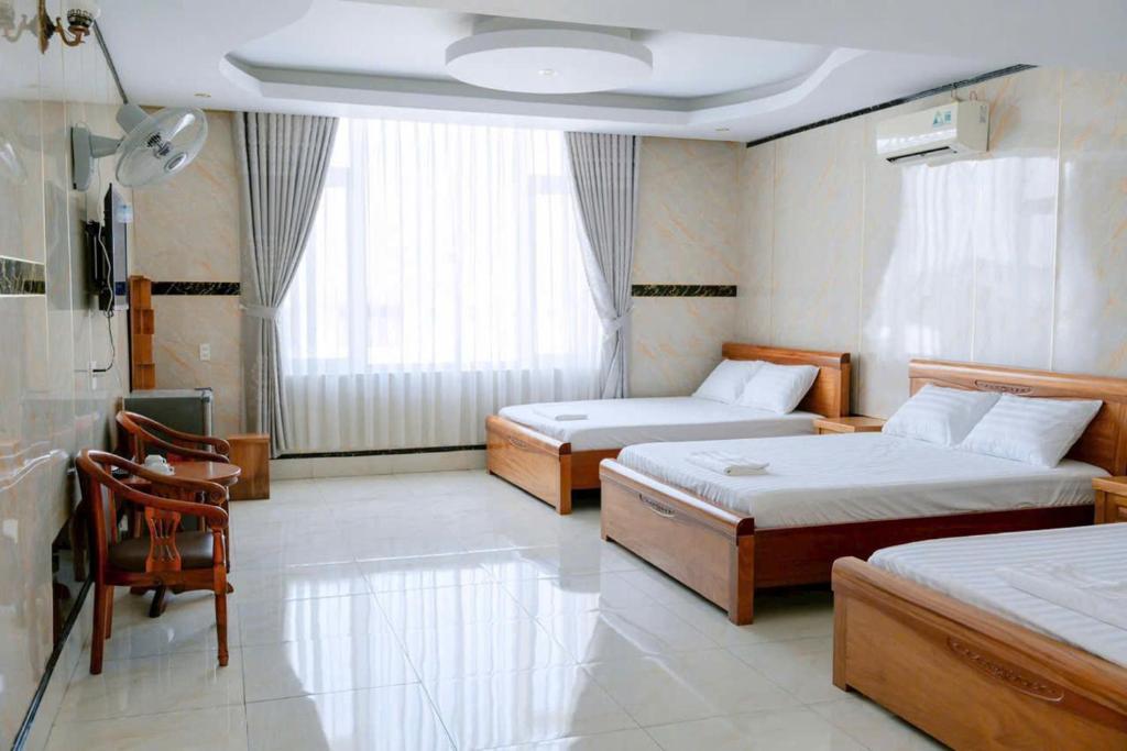 Postel nebo postele na pokoji v ubytování Thulee Luxury Hotel - Phu My