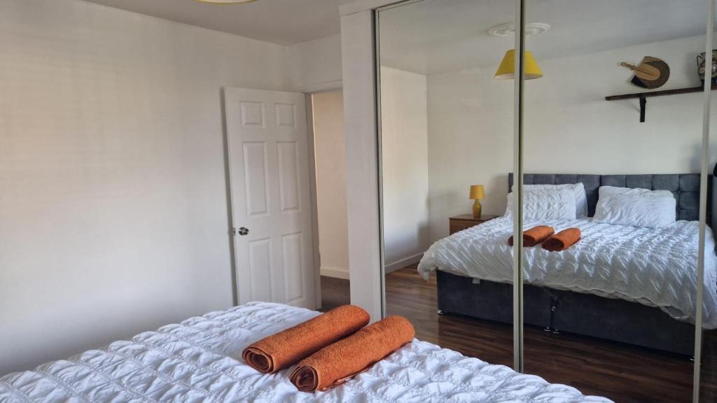 a bedroom with two beds and a mirror at Amani Bungalow in Brandon