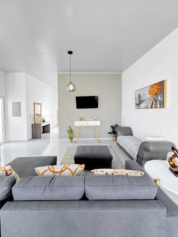 a living room with a couch and a tv at Modern Retreat in San Miguel