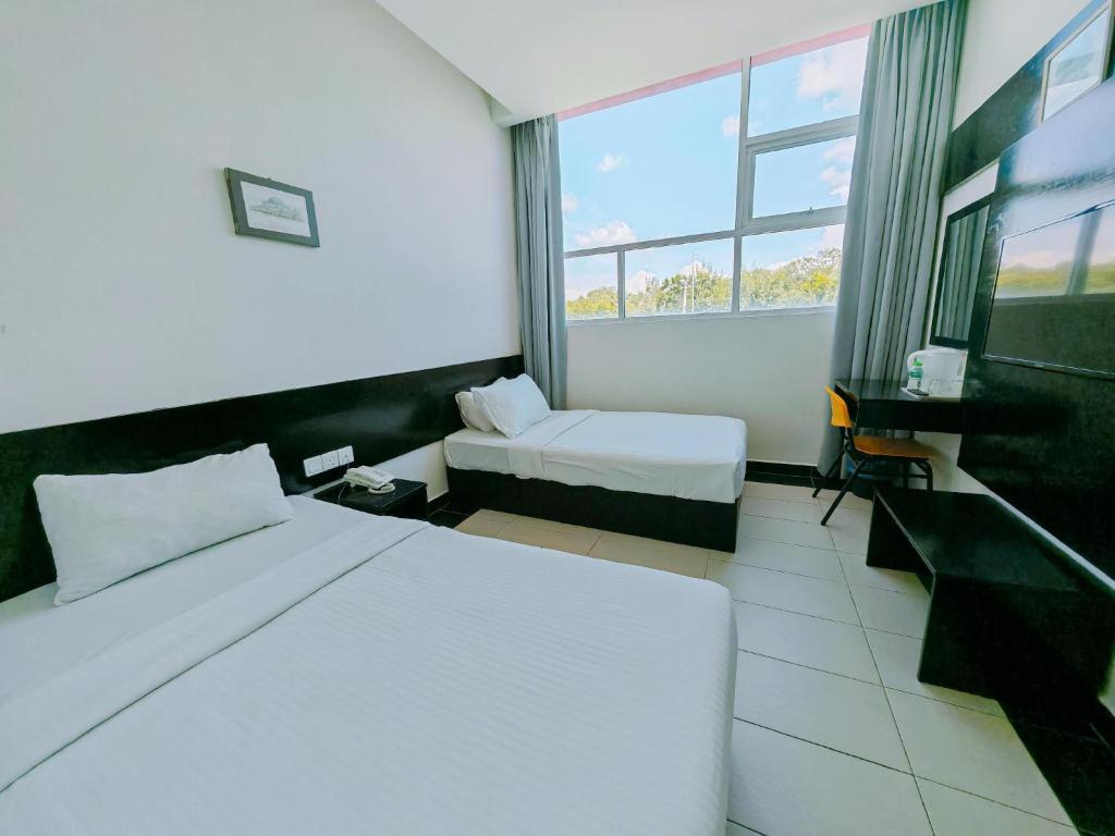Postel nebo postele na pokoji v ubytování Citrine Hotel