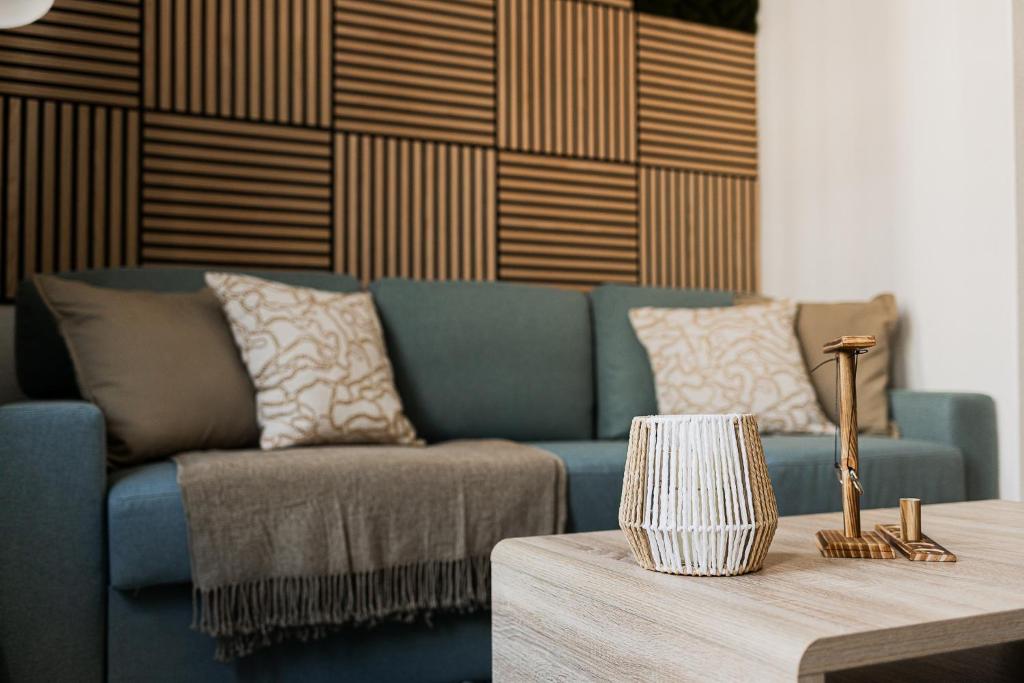 a living room with a blue couch and a table at FamilienZeit Apartments in Bremerhaven