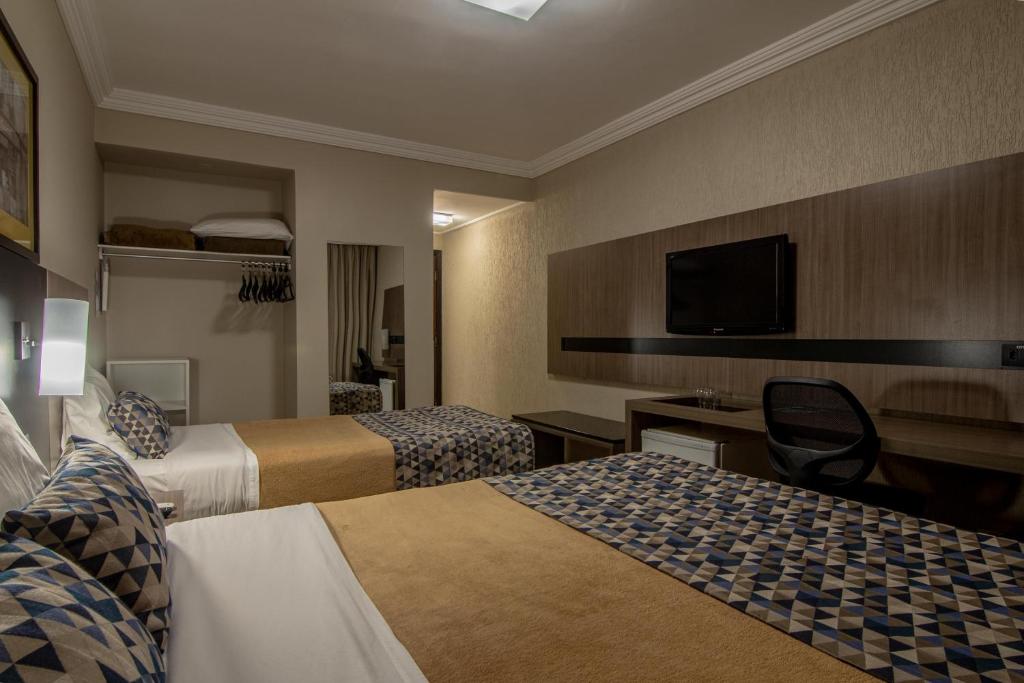 Postel nebo postele na pokoji v ubytování Hotel Deville Express Cascavel