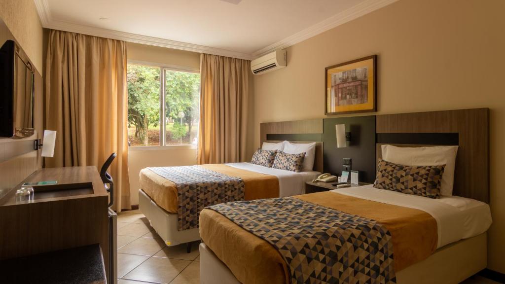 Postel nebo postele na pokoji v ubytování Hotel Deville Express Cascavel