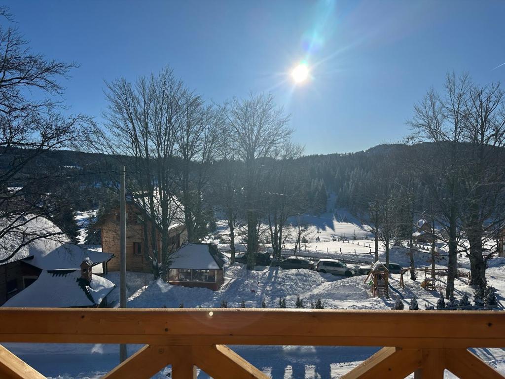 a person riding a snowboard on top of a wooden rail at Sekulic Apartman Tara in Konjska Reka