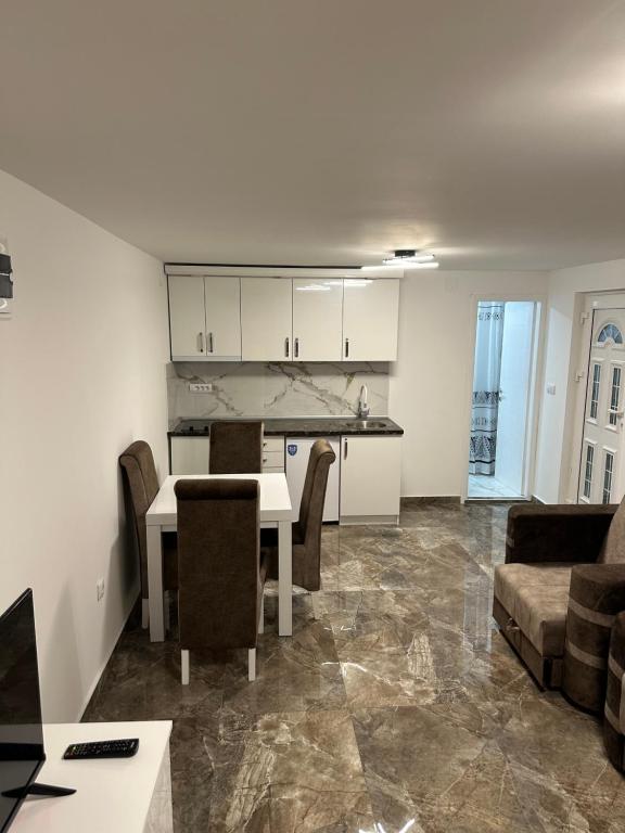 a kitchen and living room with a table and a couch at Studio Ivana 3 in Soko Banja