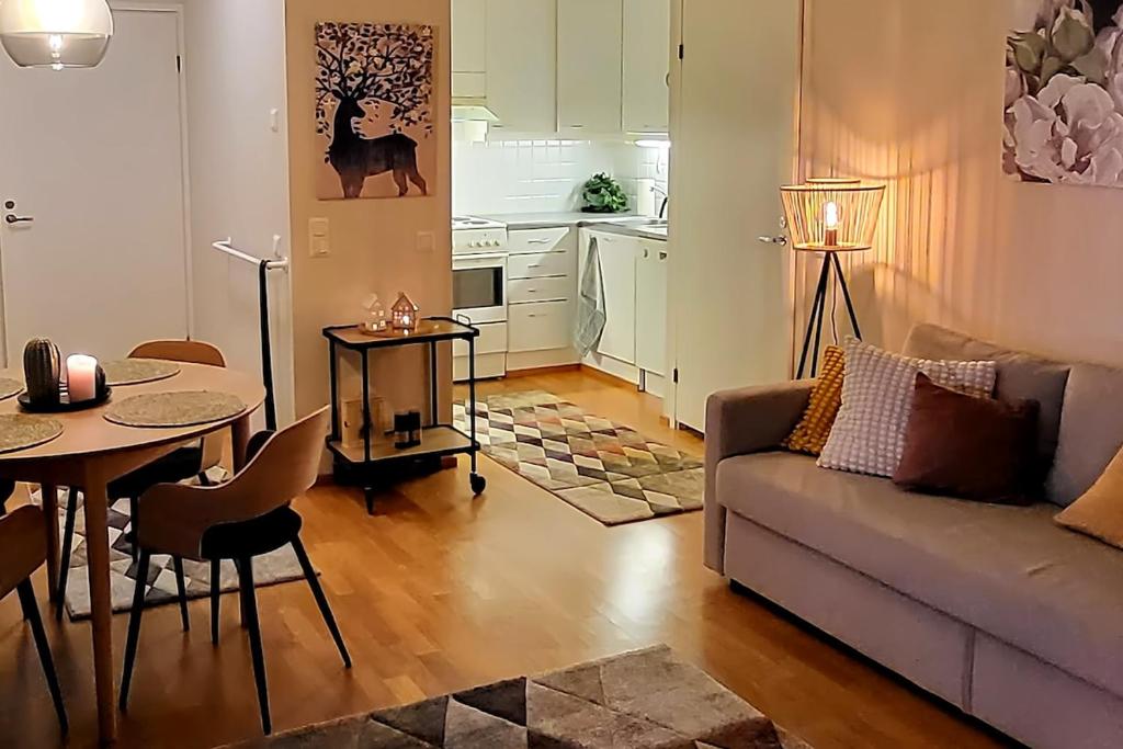 a living room with a couch and a table at Great apartment in Vantaa Close to the airport, with Sauna! in Vantaa
