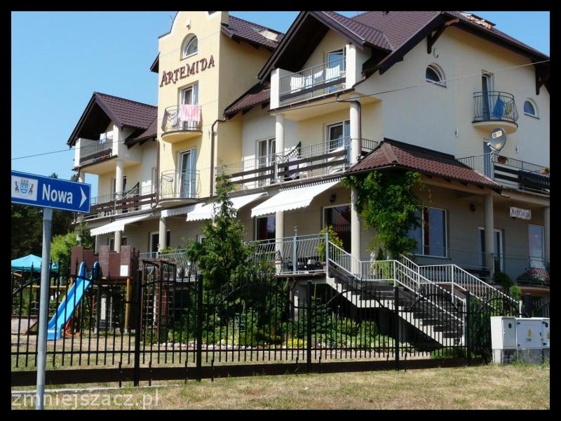 a large building with a playground in front of it at B&B Artemida in Ostrowo