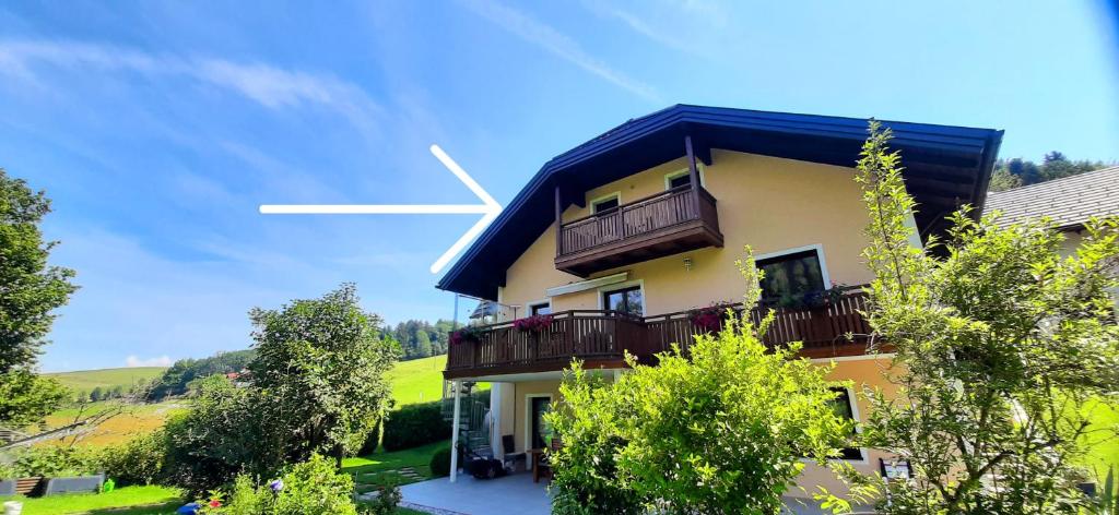 a building with a white cross on top of it at Ferienwohnung zum IRRSEE 79 Mondseeland in Zell am Moos