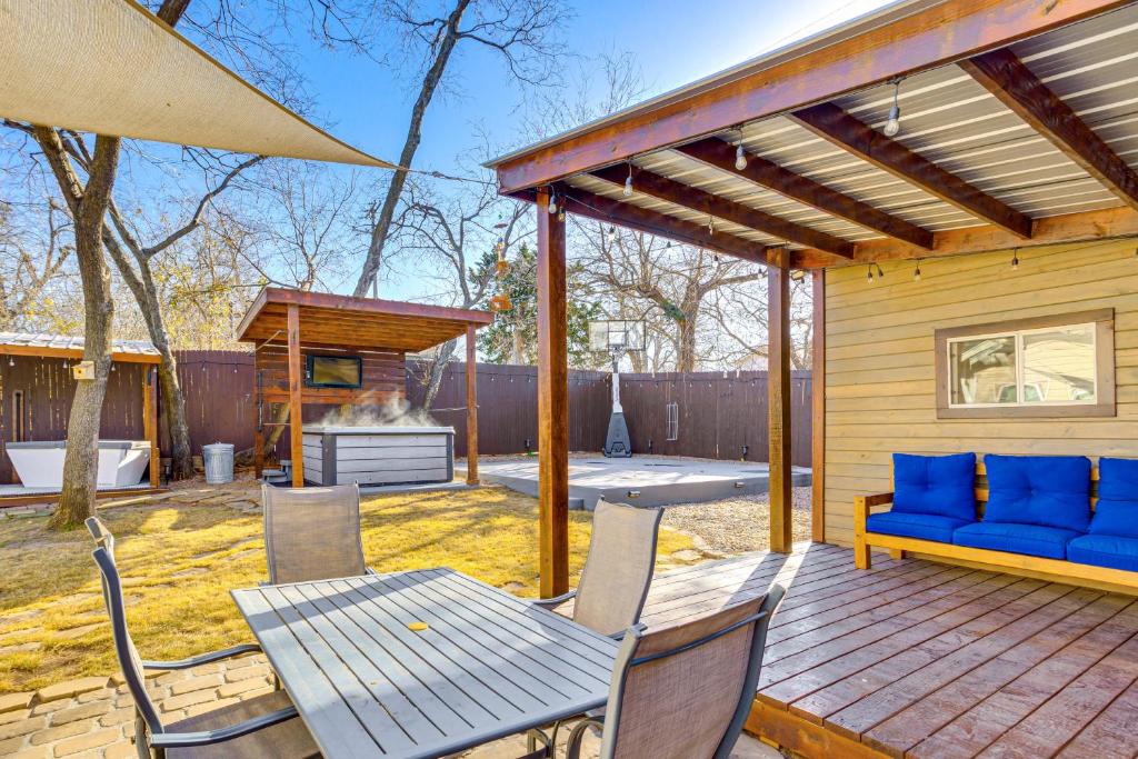 a patio with a blue couch and a table and chairs at Sauna, Hot Tub and Cold Plunge Oklahoma City Home! in Oklahoma City