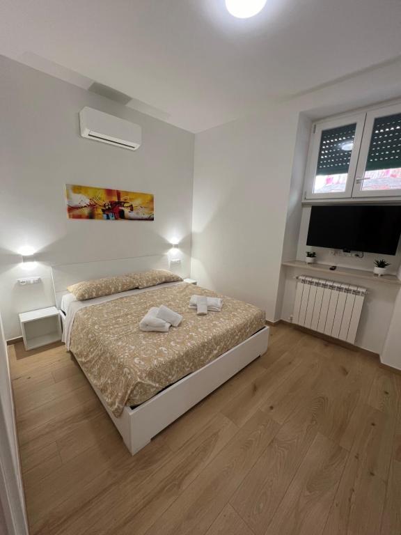 a bedroom with a bed with two towels on it at Roma Cento new apartment in Rome