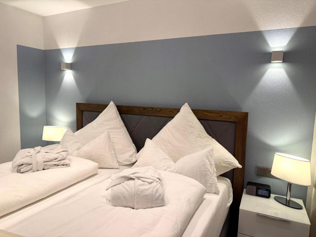 a bedroom with two beds with white pillows at Ferienwohnungen Köhnke in Hahnenklee-Bockswiese
