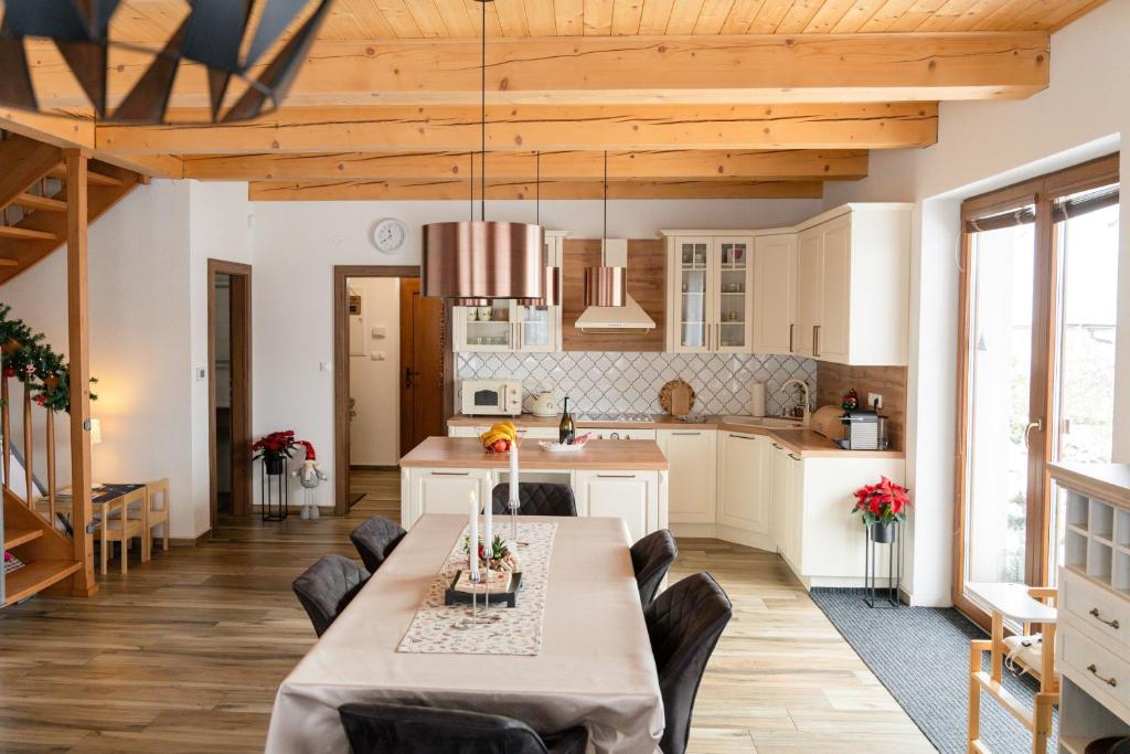 a kitchen and dining room with a table and chairs at Chalet Laura in Stará Lesná