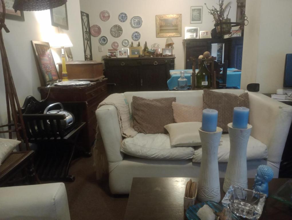 a living room with a couch and a table at Habitación single con baño privado en departamento compartido in Cordoba