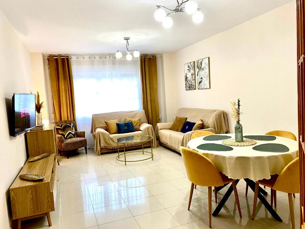 a living room with a table and a couch at Apartamento céntrico junto paseo, playas y zonas de interés!! in Águilas