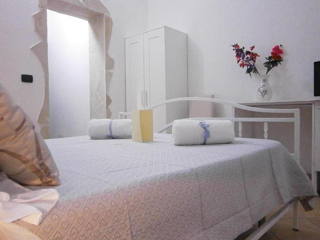 a white bed with two pillows on top of it at B&B La Rosa Lampedusa in Lampedusa