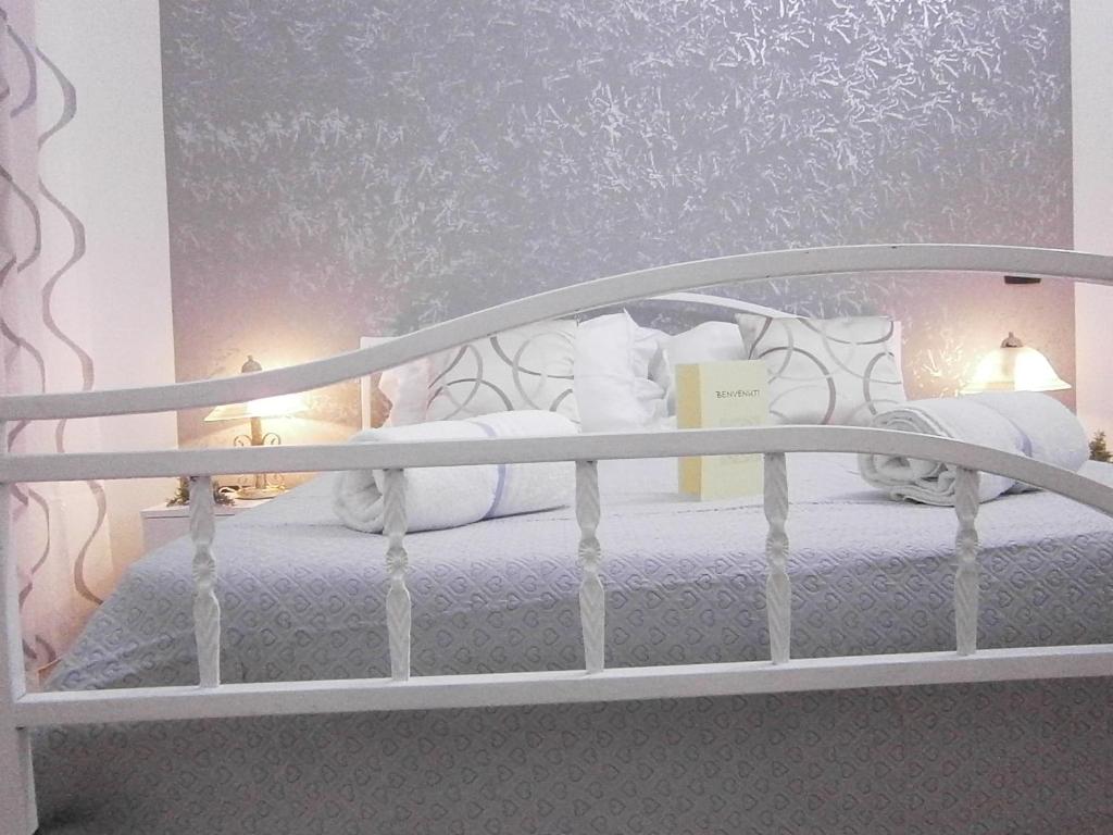 a white bed with white sheets and pillows at B&B La Rosa Lampedusa in Lampedusa