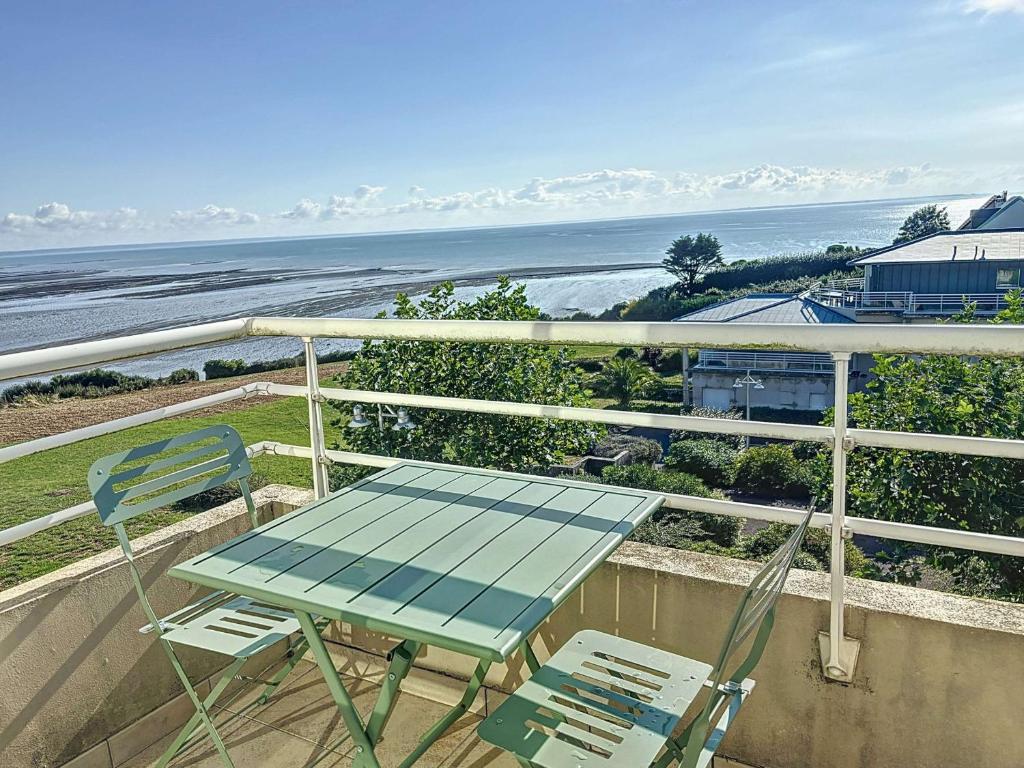 une table et des chaises sur un balcon avec l'océan dans l'établissement Appartement 2 chambres près de la plage avec balcon, ascenseur, garage et Wi-Fi gratuit - FR-1-361-487, à Granville