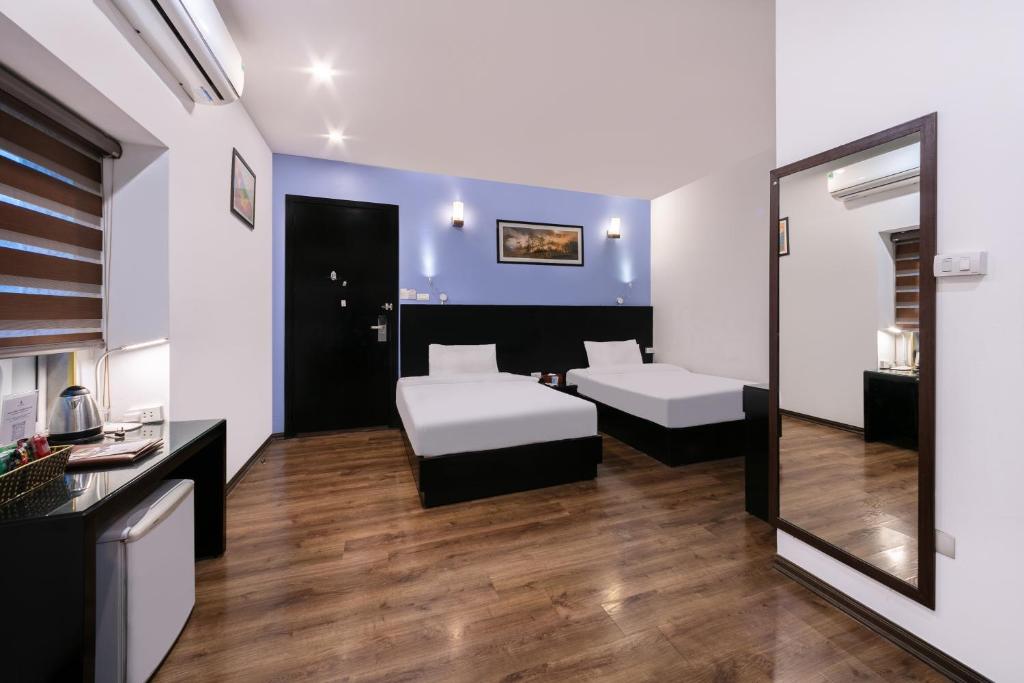Postel nebo postele na pokoji v ubytování A25 Hotel - 15 Hàng Than