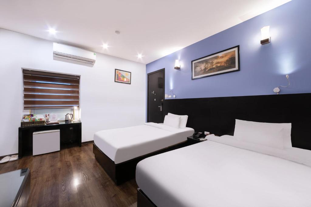 Postel nebo postele na pokoji v ubytování A25 Hotel - 15 Hàng Than