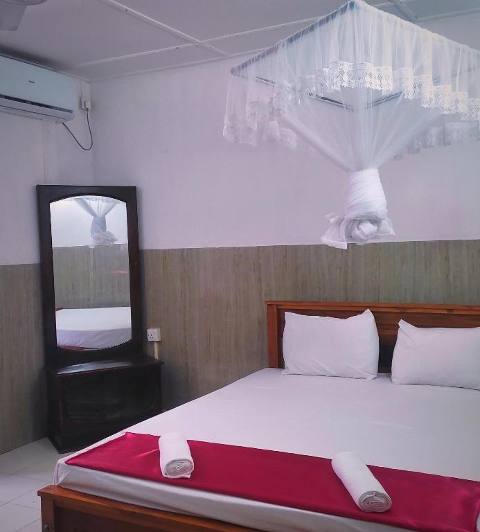 Postel nebo postele na pokoji v ubytování New Araliya Resort