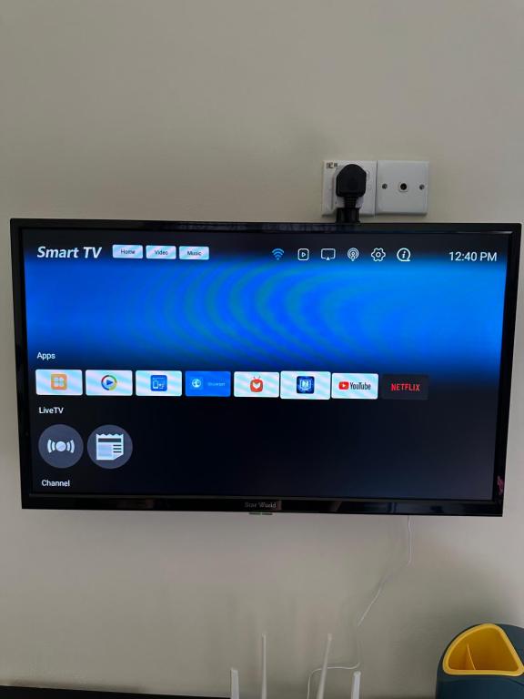 a flat screen tv hanging on a wall at Teratak Manis Homestay in Kuantan