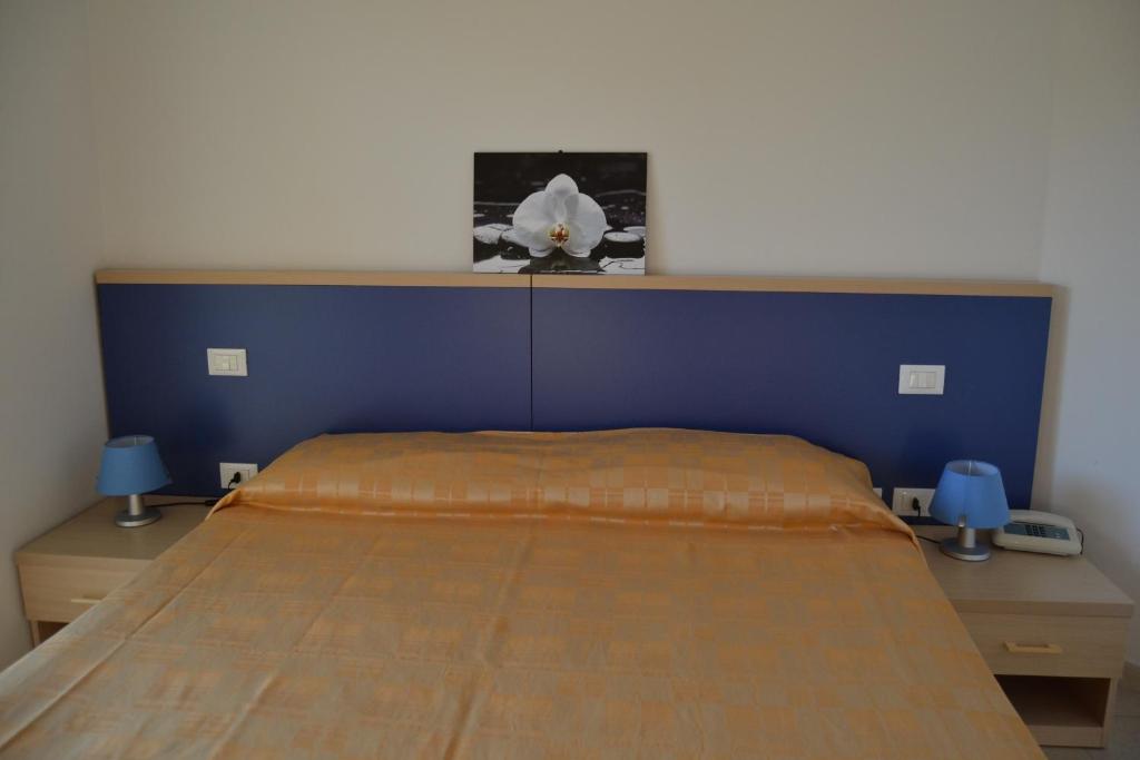 Postel nebo postele na pokoji v ubytování Hotel Quattro Palme