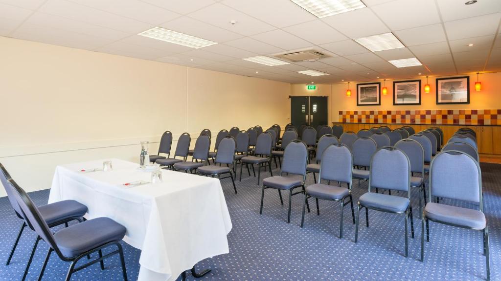 a conference room with a table and chairs at Heartland Hotel Auckland Airport in Auckland