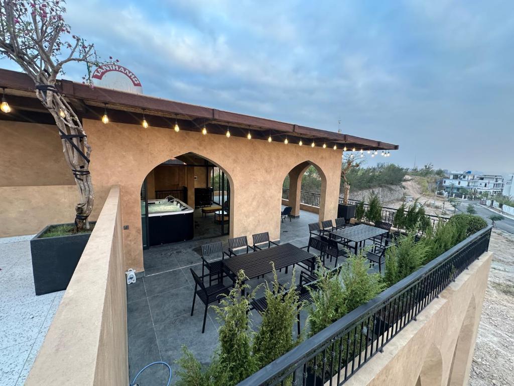 a patio with tables and chairs on a building at Palazzo Luxury Villa 950m2, 7 bedrooms, Pickleball court, swimming pool in Ha Long