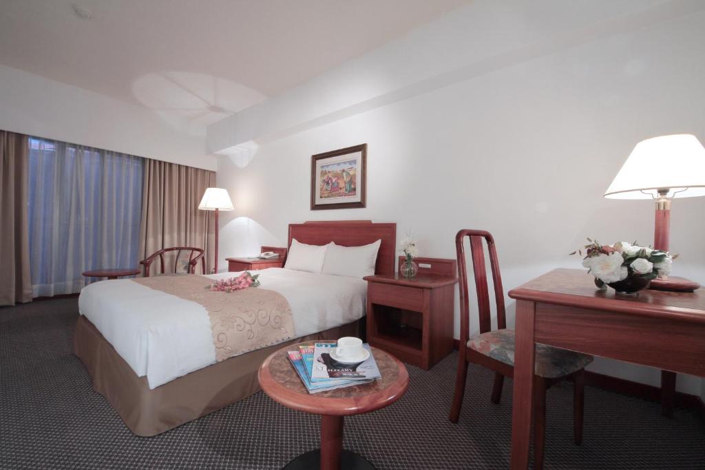 Ένα ή περισσότερα κρεβάτια σε δωμάτιο στο The Glory Hotel
