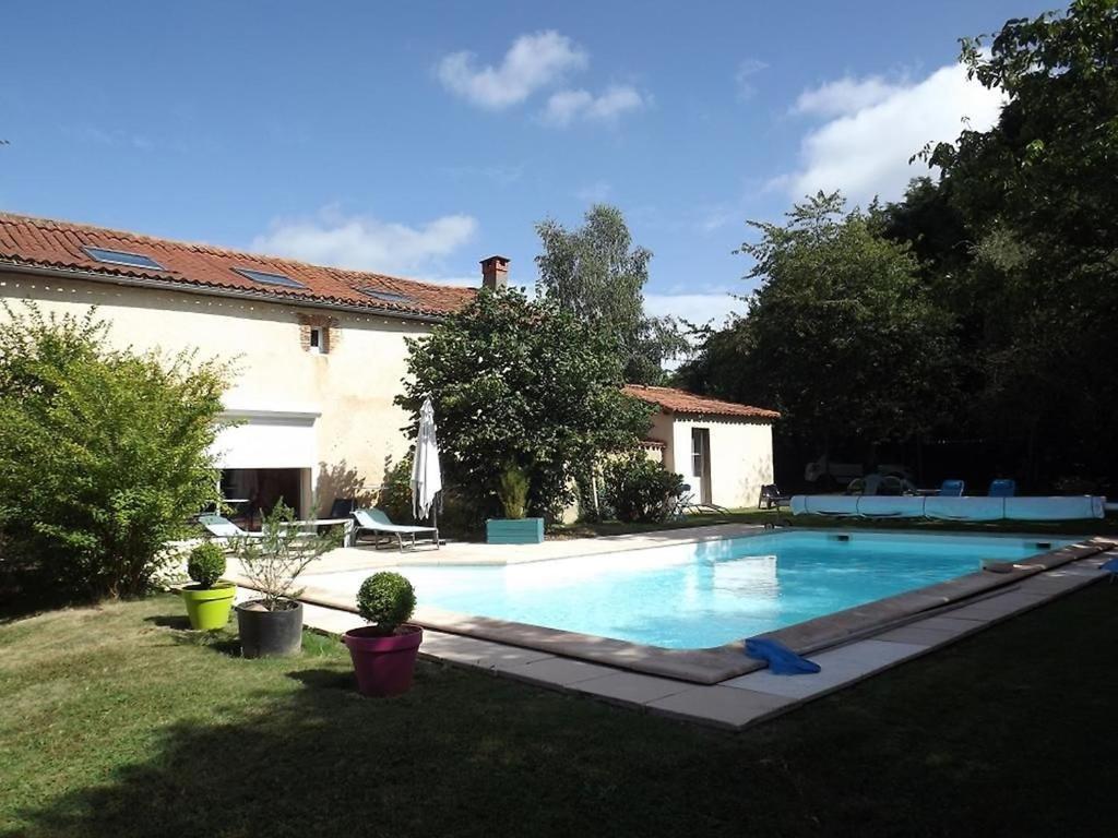a swimming pool in the yard of a house at La Gondromière 79140 CERIZAY in Cerizay