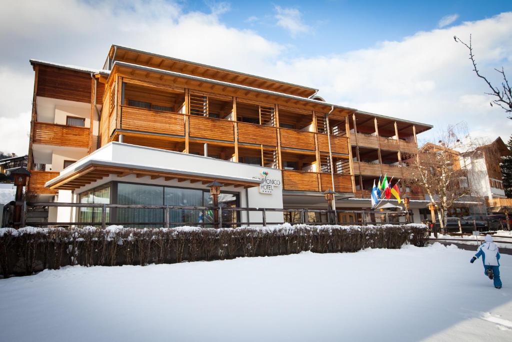 a building with snow in front of it at Olimpionico Hotel in Castello di Fiemme
