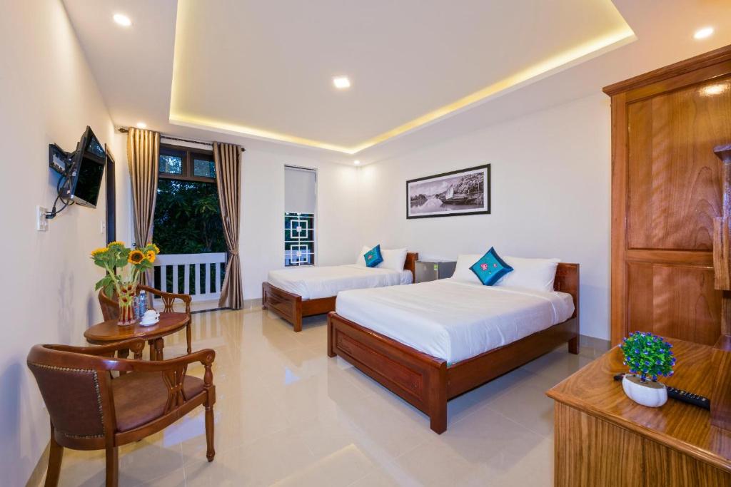 Postel nebo postele na pokoji v ubytování Papaya Garden Homestay