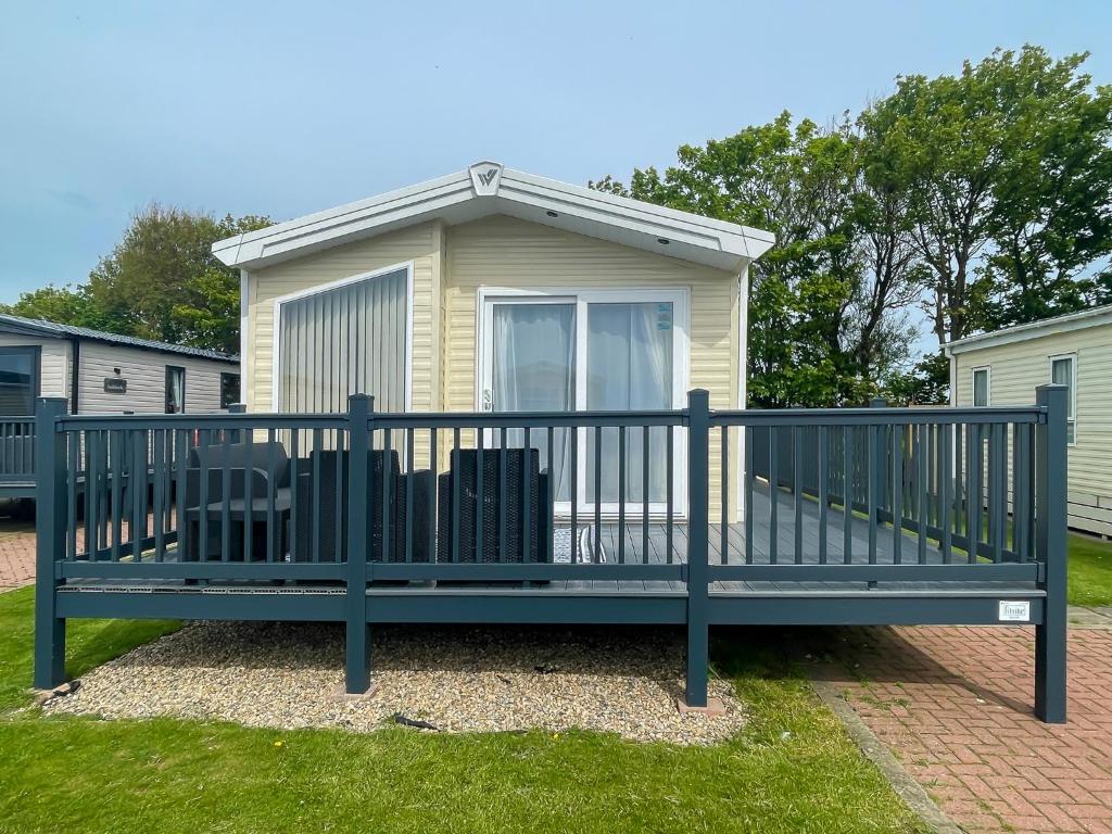 a large bench in front of a house at Luxury Coastal Bay Holiday Home in Hartley