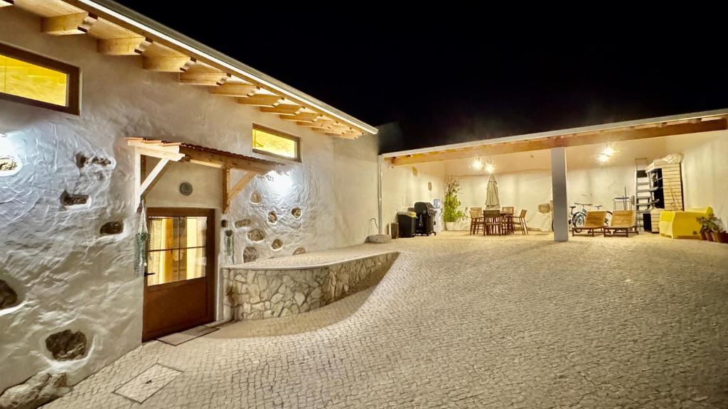 a house with a stone wall and a patio at Casa de Alcaria in Alcaria