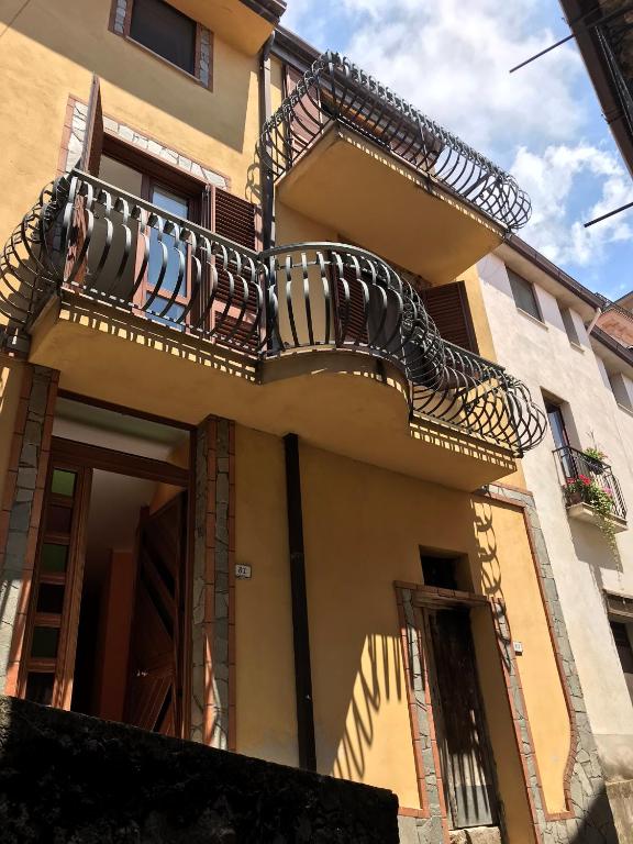 a building with balconies on the side of it at Bella casa nel cuore del Cilento in Montano Antilia