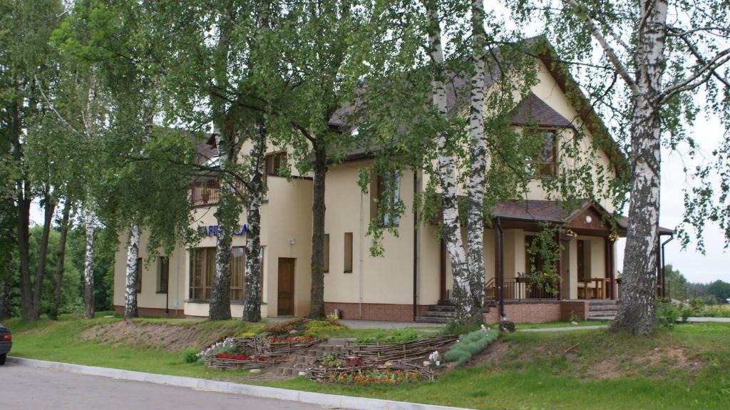 a house with trees in front of it at Rudzupuķes in Svente