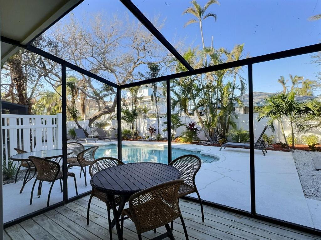 a patio with a table and chairs and a swimming pool at Crescent Beach 1015 #2 in Sarasota