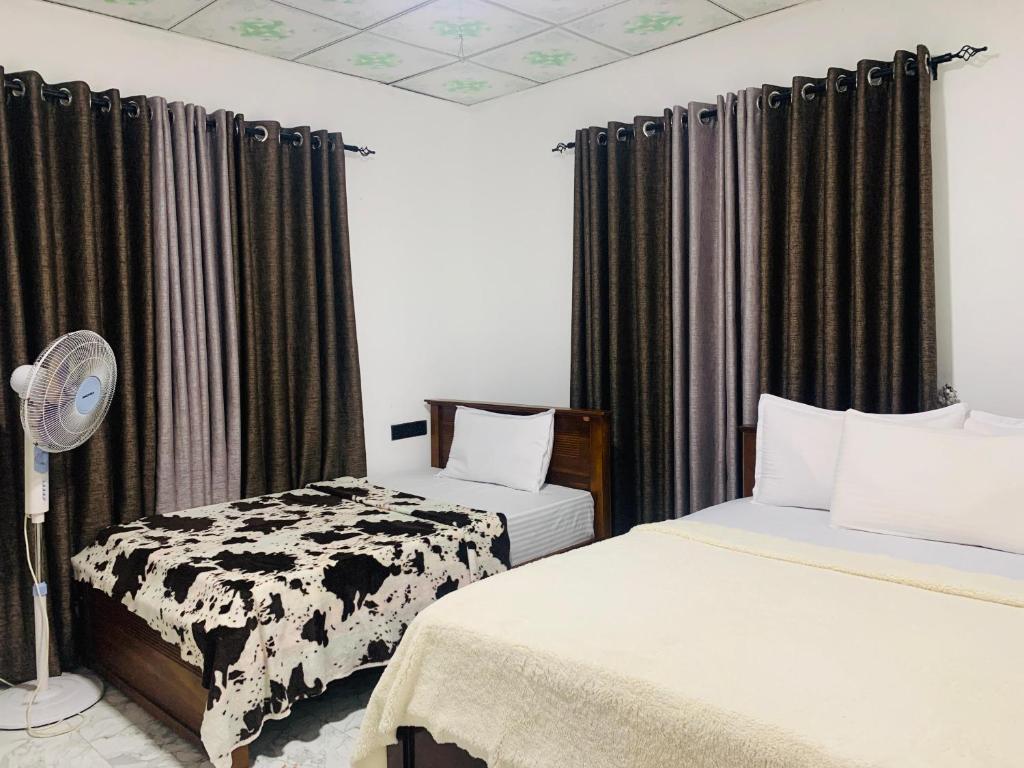 Postel nebo postele na pokoji v ubytování Nethuli Inn Ella