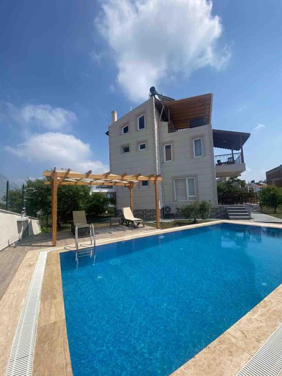 a swimming pool in front of a house at Detached villa in antkoop in Serik
