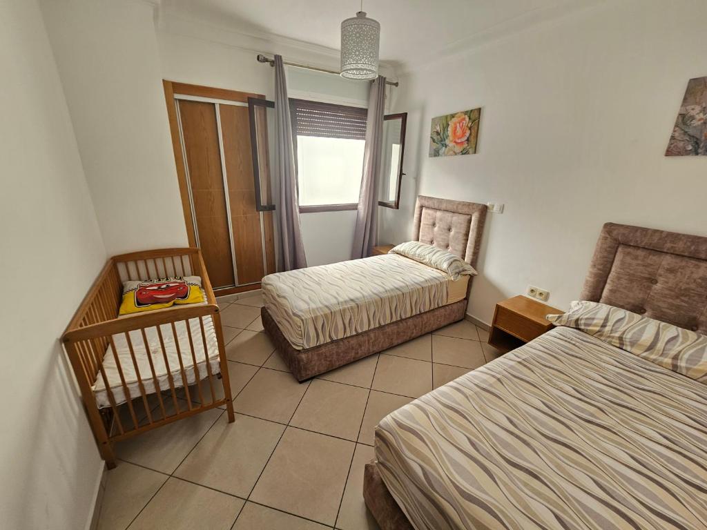 Postel nebo postele na pokoji v ubytování Appartement Al Amal