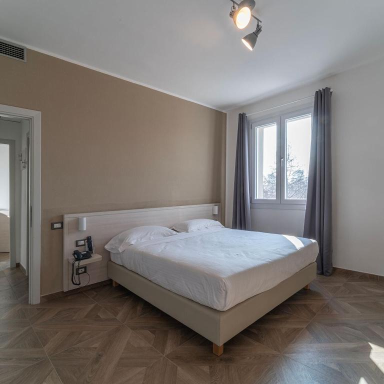 Postel nebo postele na pokoji v ubytování Hotel Donatello