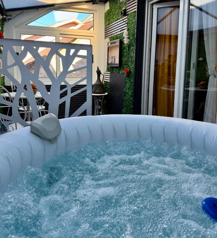 a hot tub on a patio with water at Apartments Mehić in Mostar
