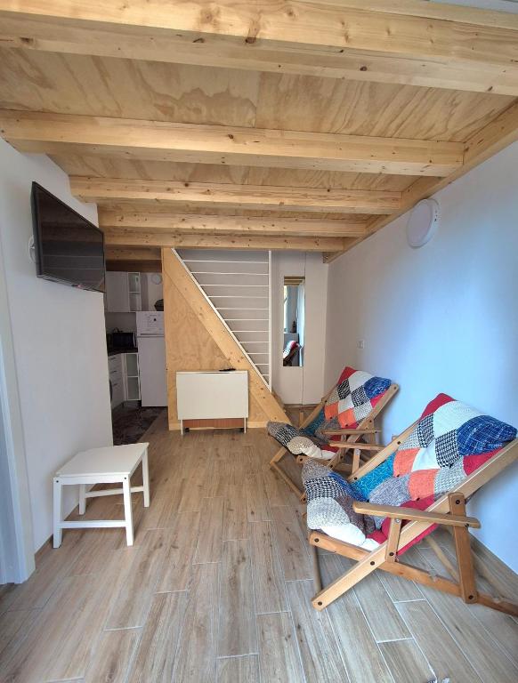 a living room with a couch and a chair at Loft piano terra a 300m dal mare in Terracina