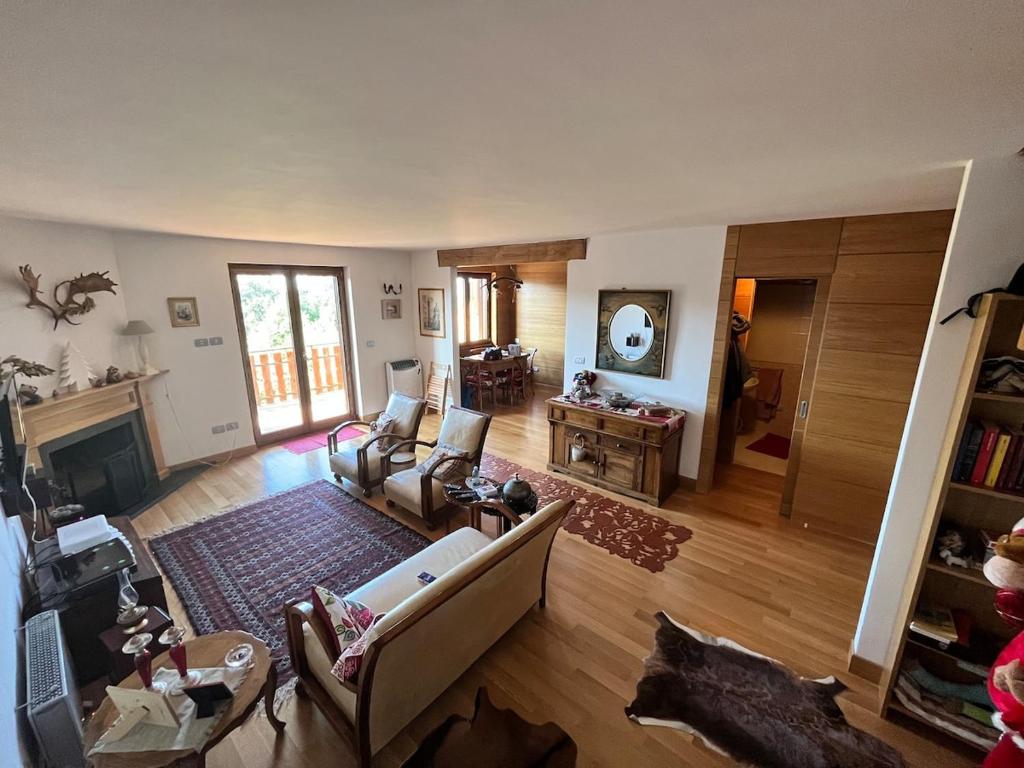 a living room with a couch and a fireplace at Splendido Chalet in Camigliatello Silano