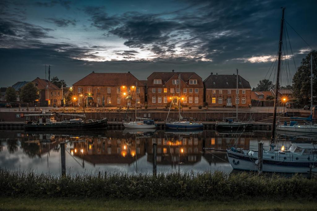 a group of boats docked in a marina at night at Hotel Packhaus in Hooksiel