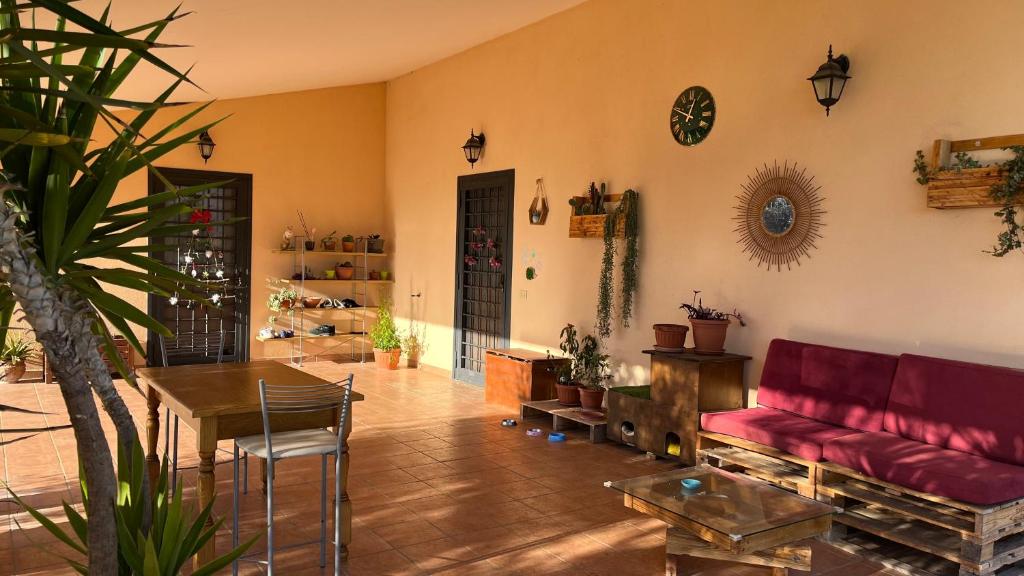 a living room with a red couch and a table at La tana dei Ricci in Fiano Romano